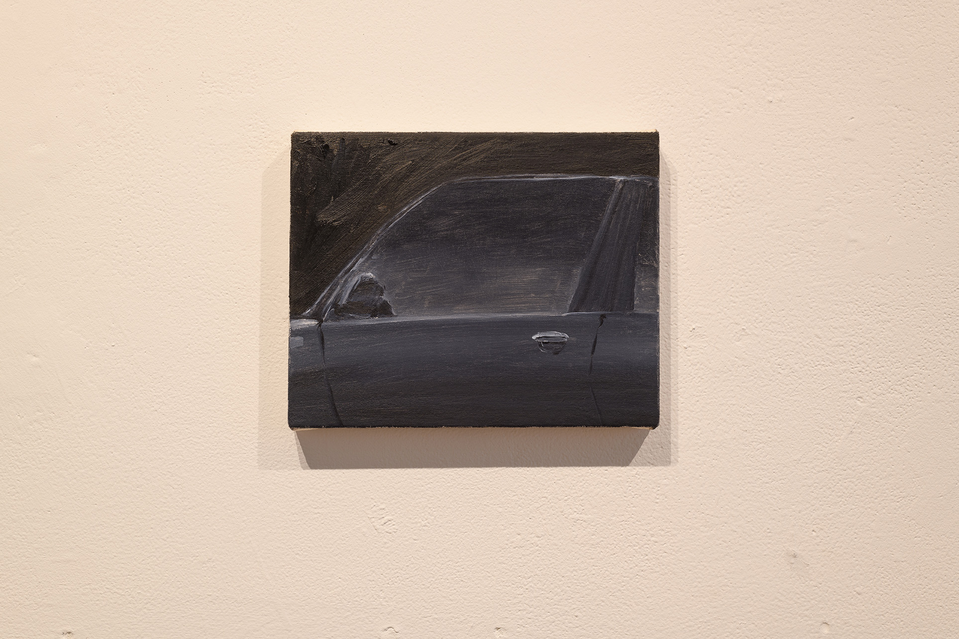 [A small painting of a car’s door and side window rendered in blacks, deep blues, and cool silver highlights surrounded by darkness.]